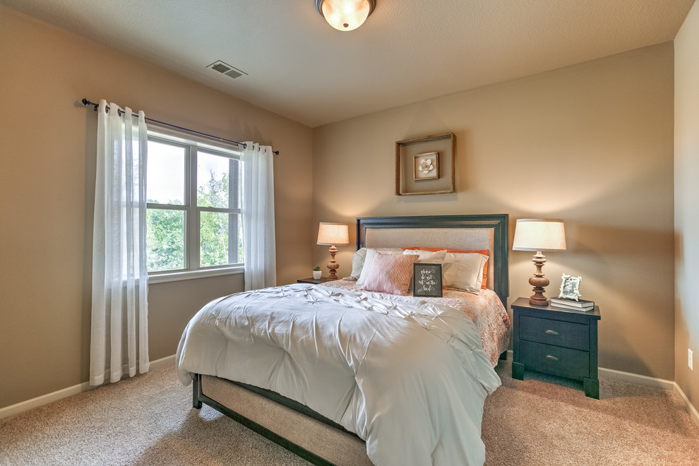This is an example of a mid-sized traditional guest bedroom in Kansas City with beige walls, carpet and beige floor.