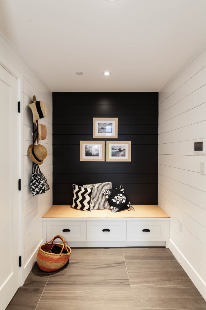 Photo of a mid-sized country mudroom in Vancouver with black walls, porcelain floors, grey floor and planked wall panelling.