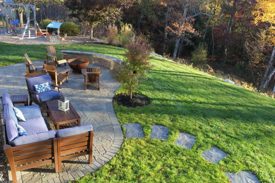 Inspiration for a small contemporary backyard patio in Manchester with a fire feature and concrete pavers.