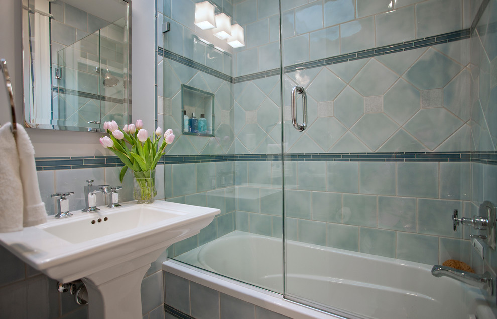 Photo of a small traditional 3/4 bathroom in DC Metro with a pedestal sink, an alcove tub, a shower/bathtub combo, a two-piece toilet, blue tile, ceramic tile, blue walls, marble floors, a hinged shower door and red floor.