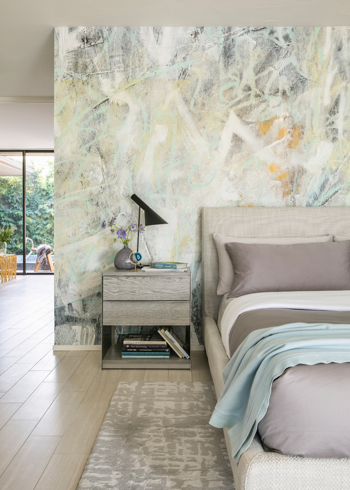 This is an example of a mid-sized contemporary master bedroom in Los Angeles with multi-coloured walls, porcelain floors and white floor.