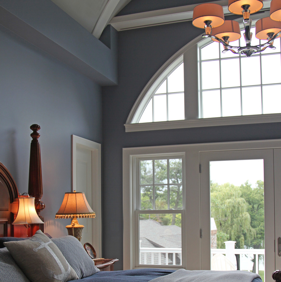 This is an example of a large traditional master bedroom in Milwaukee with grey walls, carpet and no fireplace.