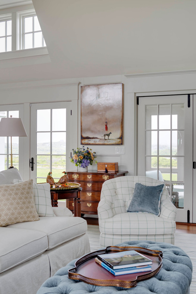 Example of a large farmhouse formal and open concept medium tone wood floor living room design in Boston with white walls, a standard fireplace, a stone fireplace and no tv