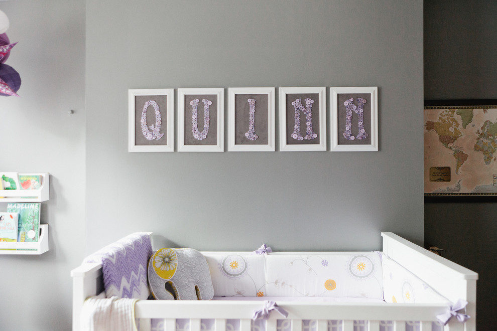 This is an example of a mid-sized eclectic nursery for girls in New York with grey walls and light hardwood floors.