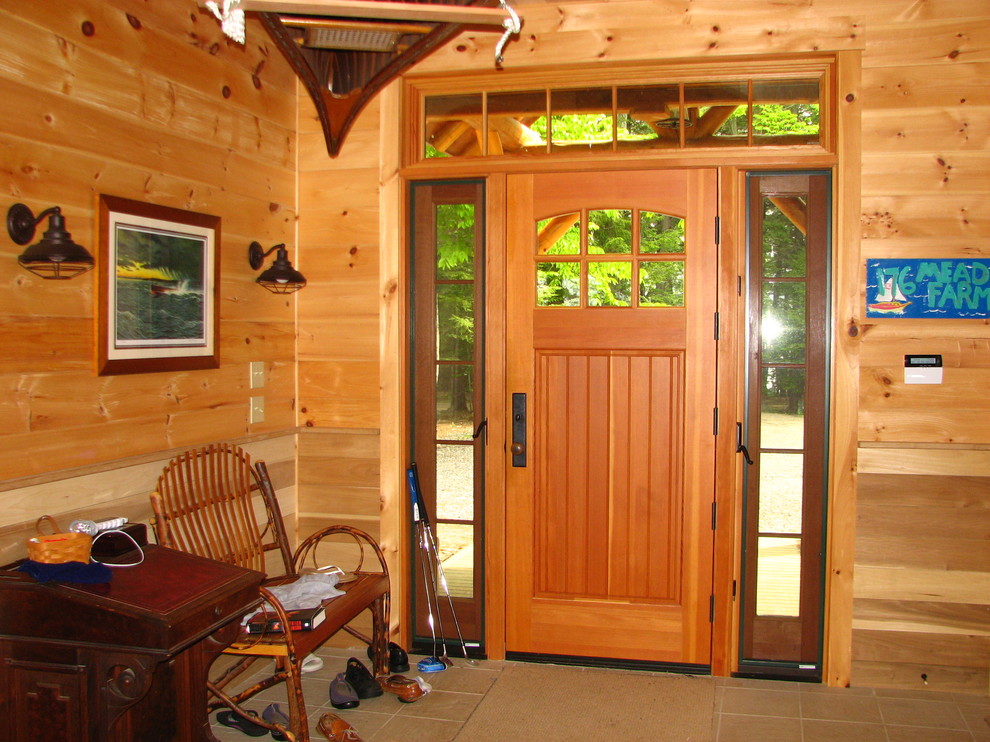 Mid-sized mountain style ceramic tile front door photo with a light wood front door