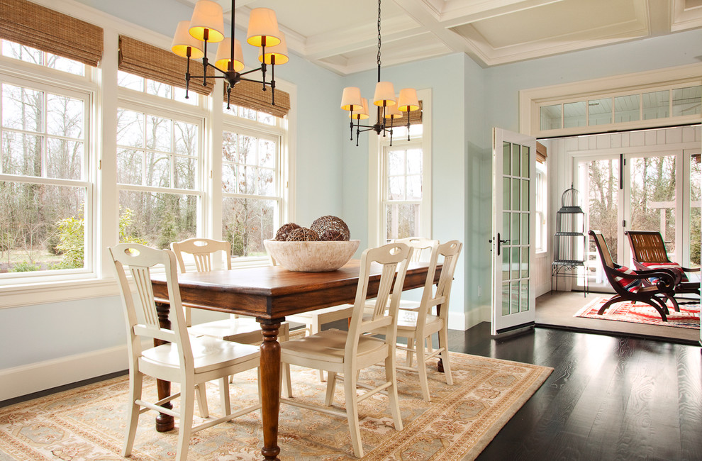 Photo of a large traditional kitchen/dining combo in Portland with blue walls, dark hardwood floors and brown floor.