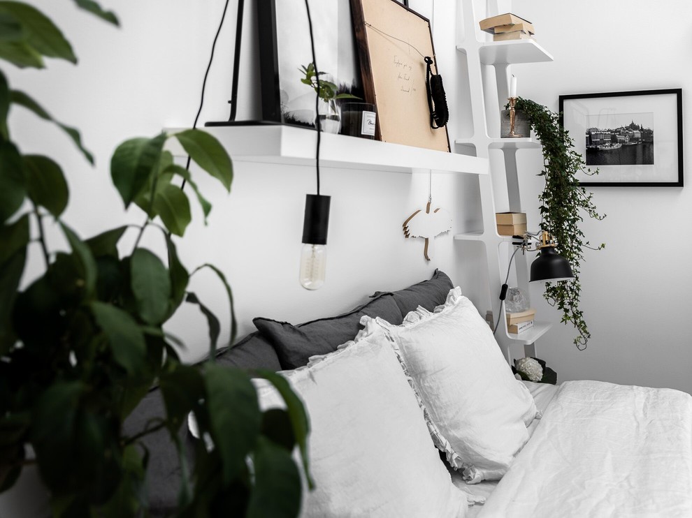 Inspiration for a scandinavian master bedroom in Stockholm with white walls.