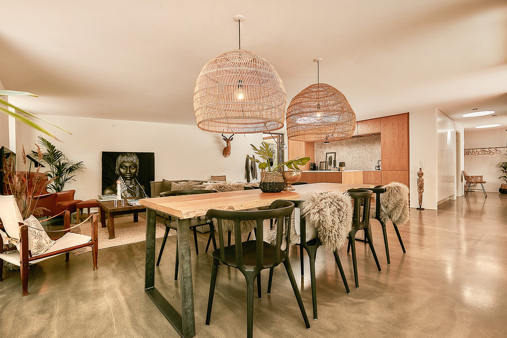 This is an example of a mid-sized contemporary open plan dining in Copenhagen with white walls, concrete floors and grey floor.