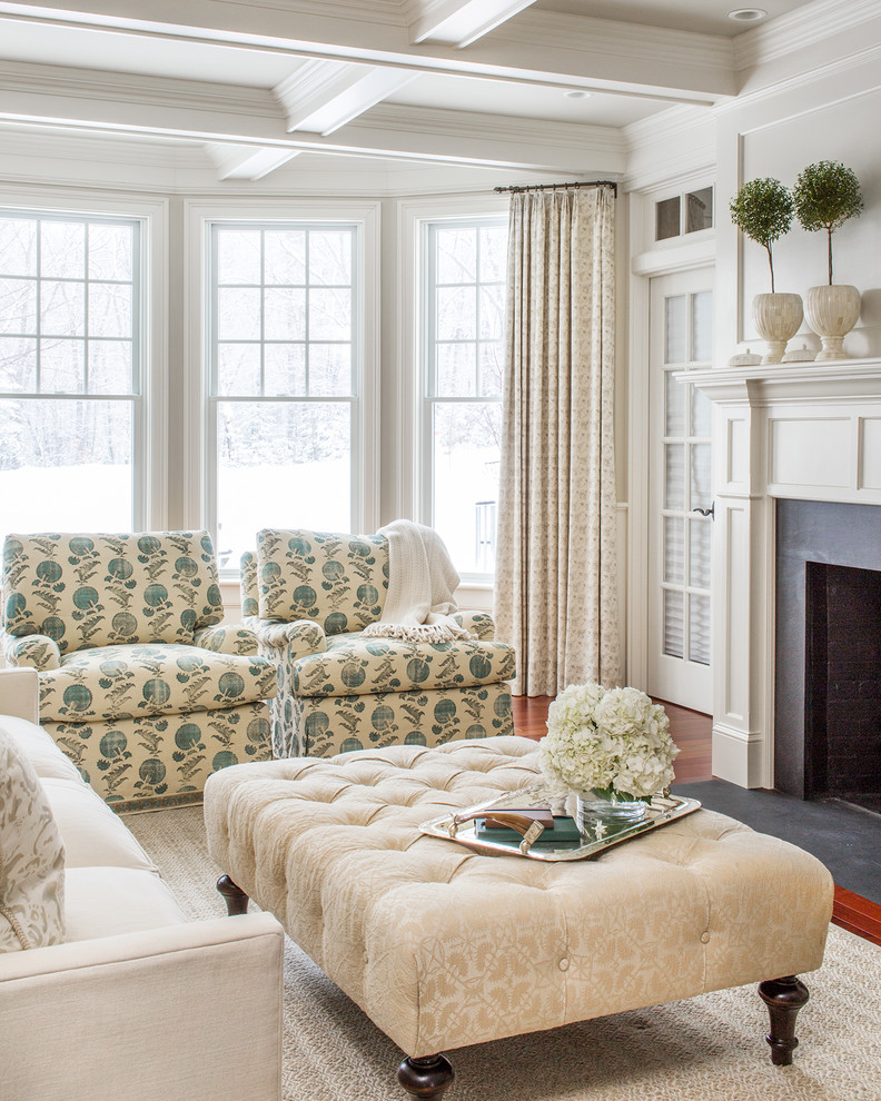 Traditional formal living room in Boston with white walls, medium hardwood floors and a standard fireplace.