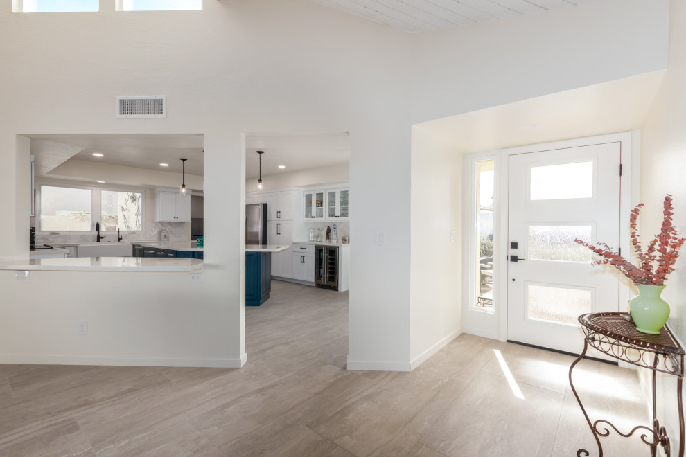 Transitional gray floor kitchen photo in Phoenix with a farmhouse sink, shaker cabinets, white cabinets and subway tile backsplash