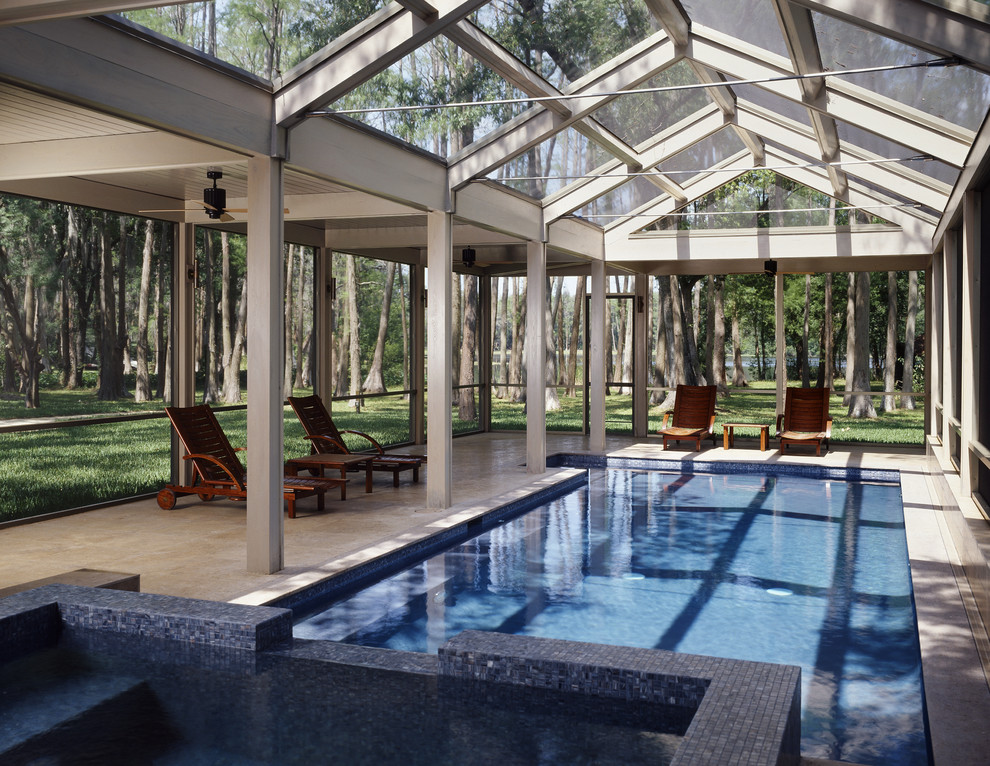 This is an example of a large contemporary indoor rectangular pool in Tampa with a hot tub.