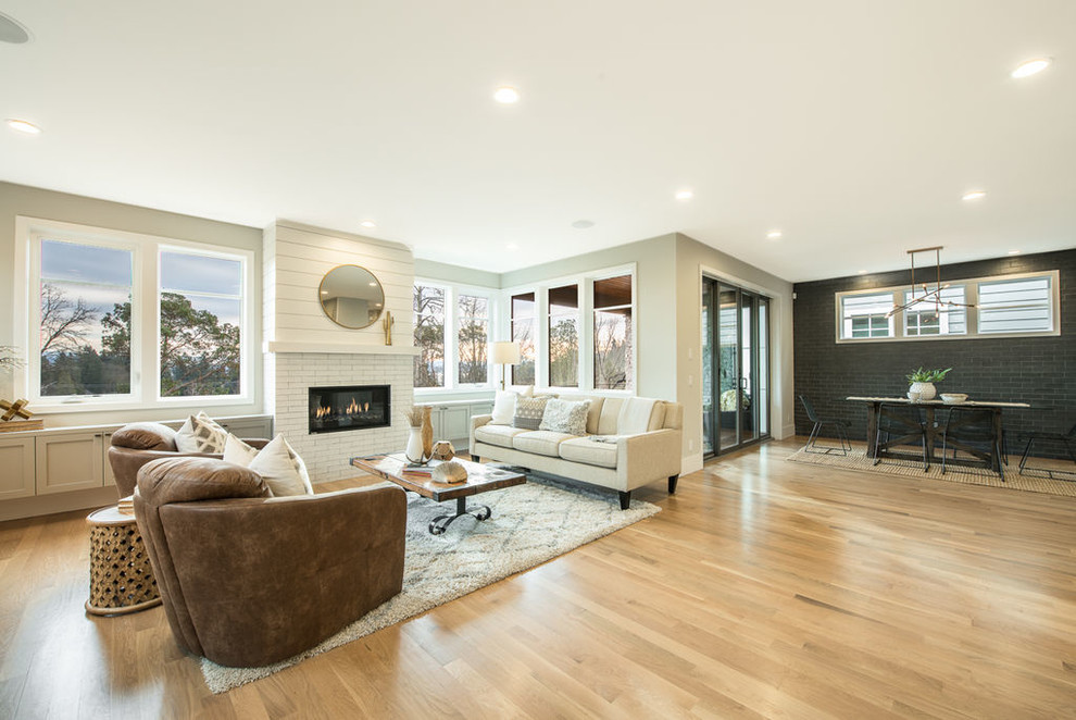 Mid-sized transitional formal open concept living room in Seattle with beige walls, light hardwood floors, a standard fireplace, a brick fireplace surround, no tv and beige floor.