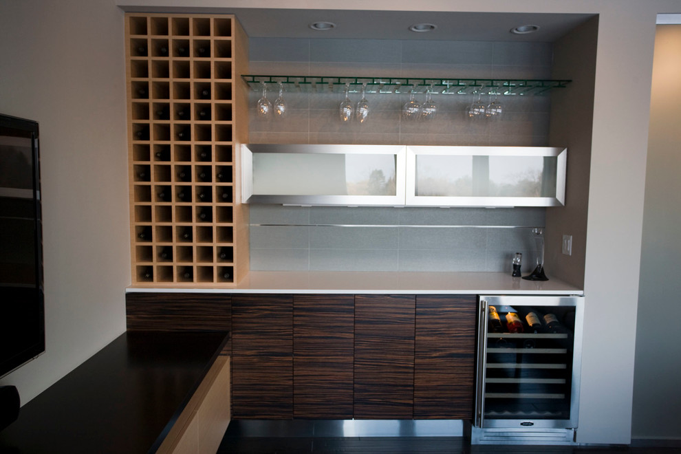 Photo of a large modern single-wall wet bar in Minneapolis with flat-panel cabinets, brown cabinets, quartz benchtops, grey splashback and dark hardwood floors.