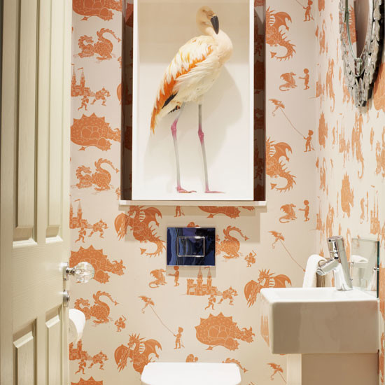 Photo of a small contemporary powder room in Other with a one-piece toilet and orange walls.