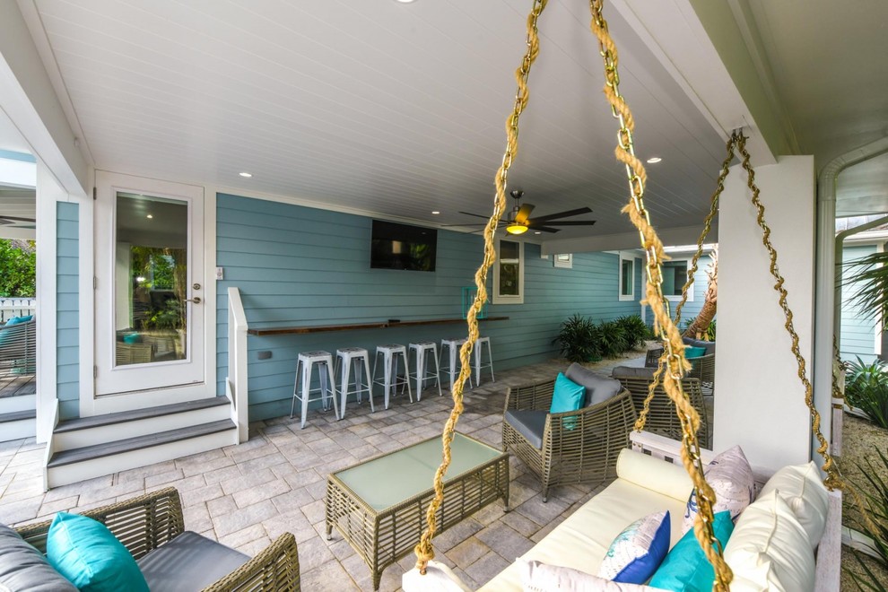 Design ideas for a beach style side yard patio in Tampa.