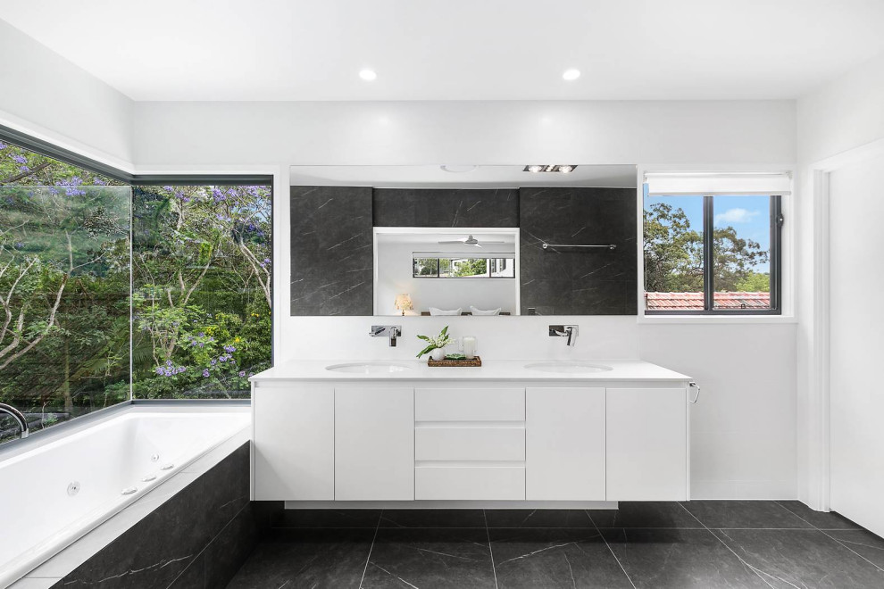 Design ideas for a mid-sized contemporary master bathroom in Brisbane with shaker cabinets, white cabinets, a hot tub, an alcove shower, a one-piece toilet, black and white tile, porcelain tile, black walls, porcelain floors, an undermount sink, engineered quartz benchtops, black floor, an open shower, white benchtops, a niche, a double vanity and a floating vanity.