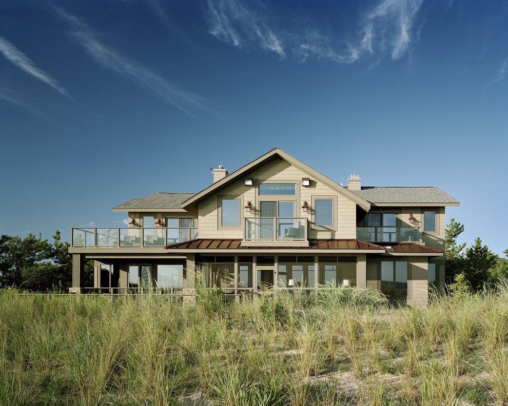 Inspiration for a mid-sized beach style two-storey brown exterior in Wilmington with wood siding.