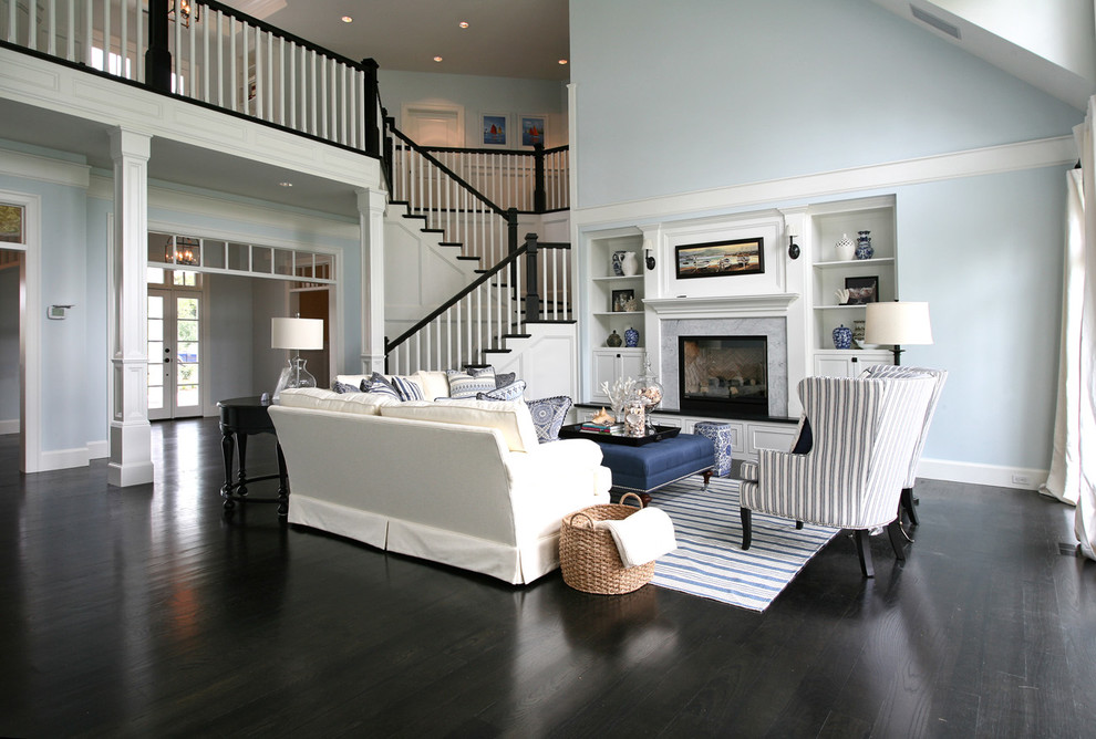 Design ideas for a traditional living room in Portland with blue walls and black floor.