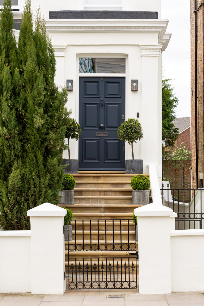 Traditional entryway in London with a single front door and a black front door.