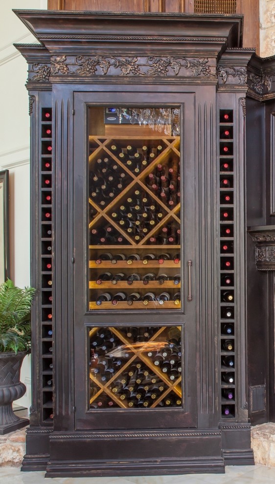 Inspiration for a large traditional wine cellar in Houston with marble floors, display racks and white floor.