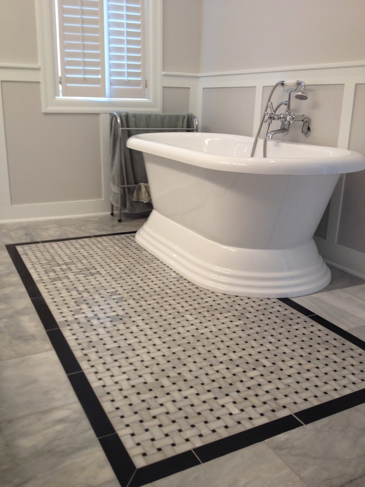 Design ideas for a mid-sized traditional master bathroom in Other with a vessel sink, raised-panel cabinets, white cabinets, granite benchtops, a freestanding tub, an alcove shower, white tile, stone tile, grey walls and marble floors.