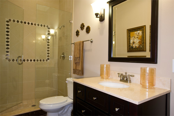 Photo of a mid-sized traditional 3/4 bathroom in Tampa with flat-panel cabinets, black cabinets, a curbless shower, a two-piece toilet, beige tile, white walls, dark hardwood floors and an undermount sink.
