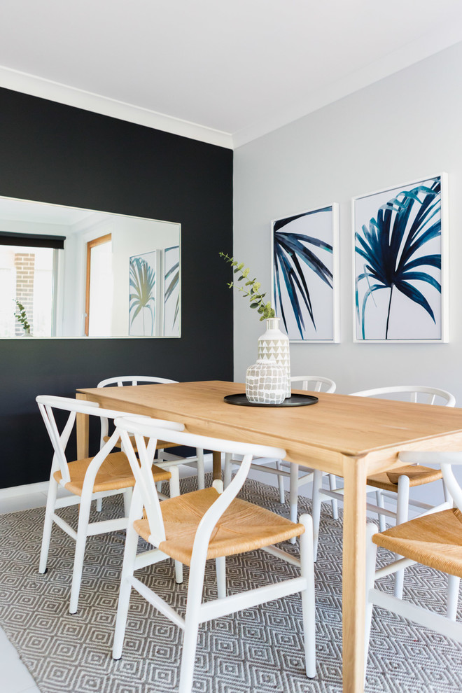 Photo of a beach style separate dining room in Sydney with black walls, ceramic floors and white floor.