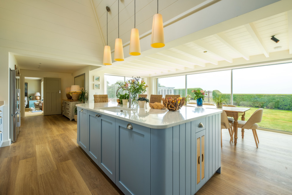 Inspiration for a large beach style kitchen in Sussex with shaker cabinets, blue cabinets and with island.