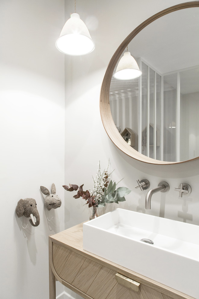 Design ideas for a mid-sized scandinavian kids bathroom in Paris with grey cabinets, an undermount tub, grey walls, cement tiles, a drop-in sink, wood benchtops, grey floor, beaded inset cabinets, a shower/bathtub combo, a wall-mount toilet, gray tile, ceramic tile, a hinged shower door, beige benchtops, a single vanity and a freestanding vanity.