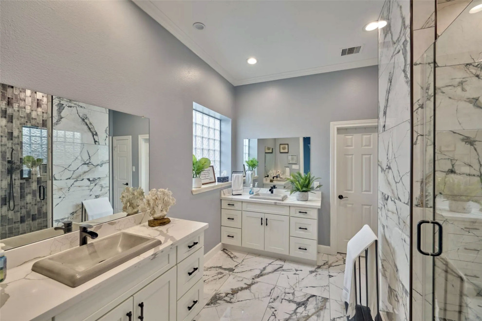 Large master white tile and marble tile marble floor, white floor and double-sink wet room photo with white cabinets, gray walls, marble countertops, a hinged shower door and a built-in vanity