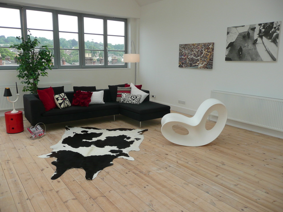 Inspiration for a modern living room in London with white walls and light hardwood floors.