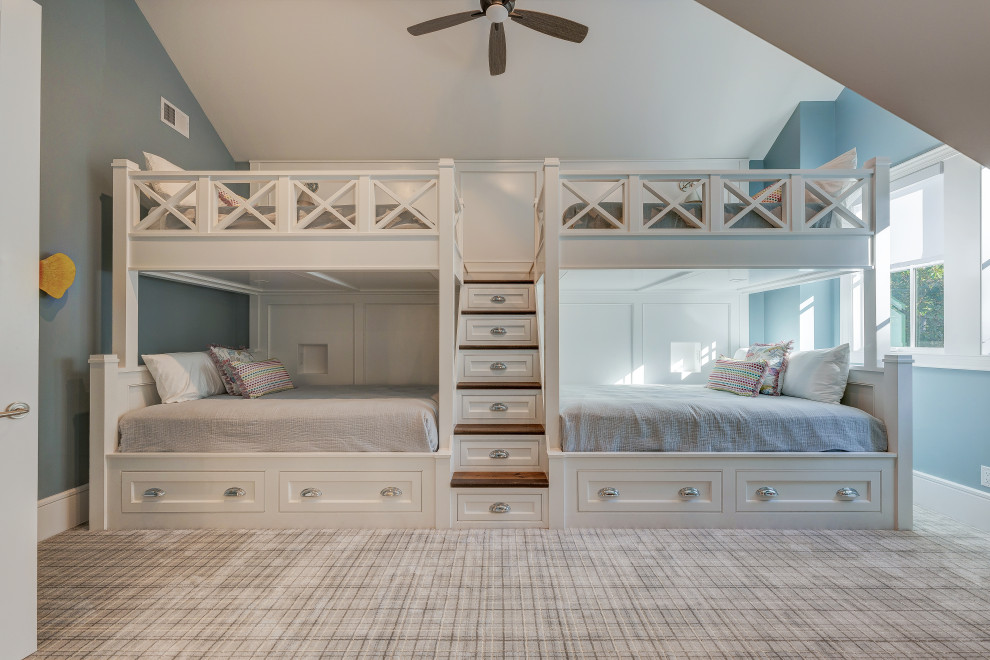 Mid-sized beach style guest bedroom in Other with blue walls, carpet, beige floor and vaulted.