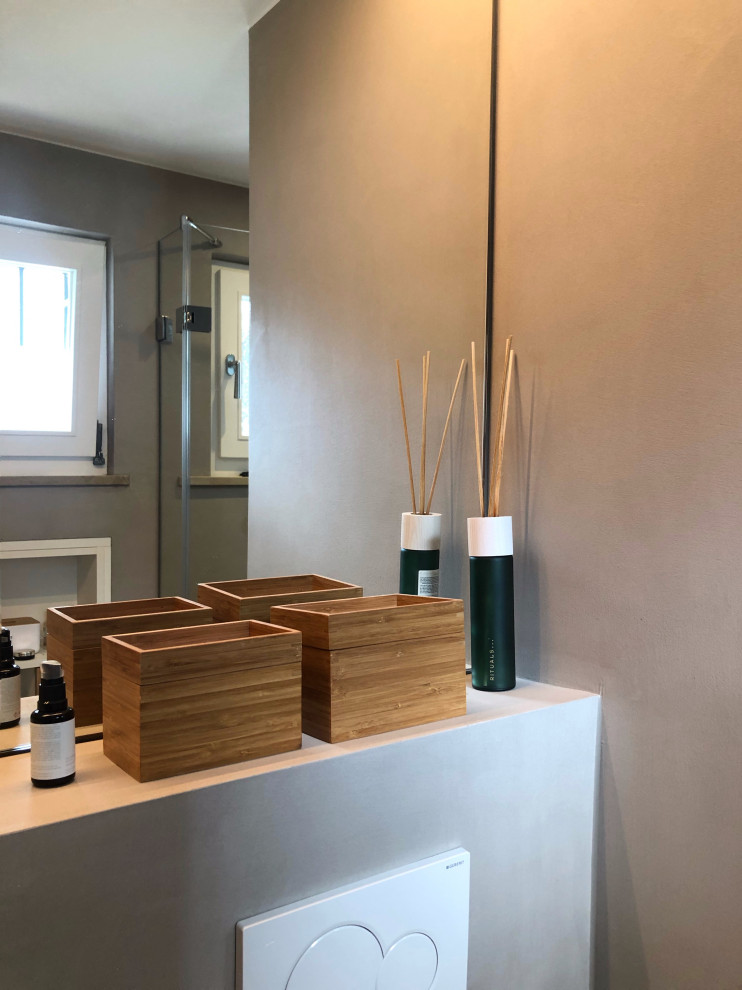 Small contemporary shower room bathroom in Munich with flat-panel cabinets, white cabinets, a walk-in shower, a wall mounted toilet, beige walls, mosaic tile flooring, a vessel sink, pink floors, an open shower, white worktops, a single sink and a built in vanity unit.