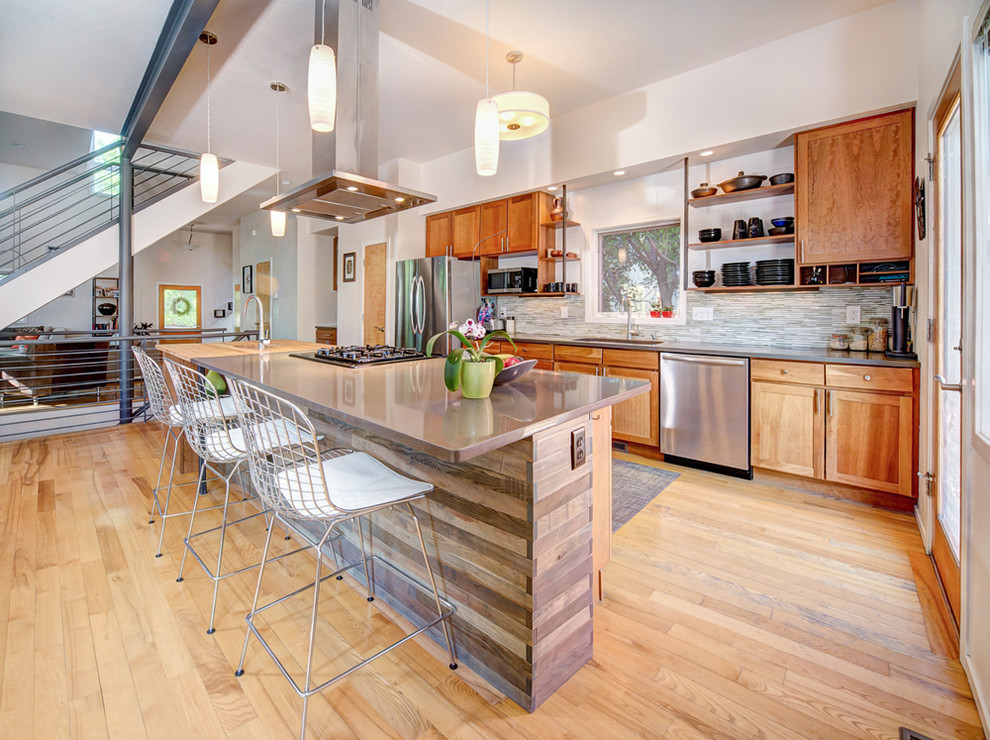 Photo of a small contemporary galley eat-in kitchen in Denver with recessed-panel cabinets, medium wood cabinets, quartzite benchtops, multi-coloured splashback, mosaic tile splashback, stainless steel appliances, a single-bowl sink, light hardwood floors and with island.