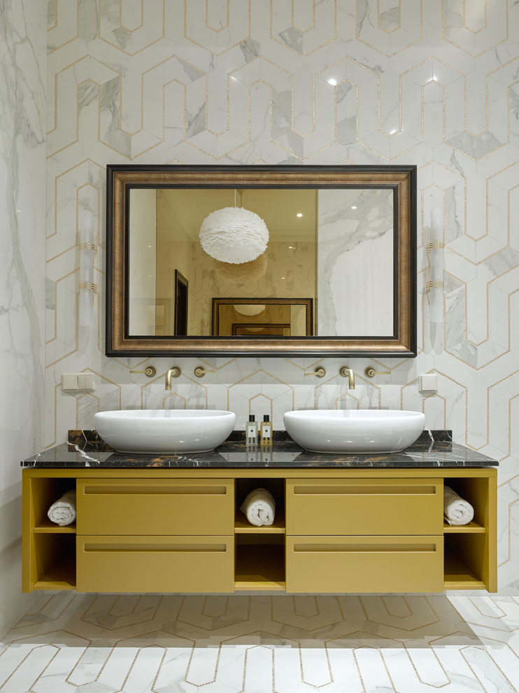 Inspiration for a transitional master bathroom in Moscow with flat-panel cabinets, yellow cabinets, white tile, gray tile, a vessel sink, white floor, black benchtops, a freestanding tub, marble, white walls, mosaic tile floors and marble benchtops.