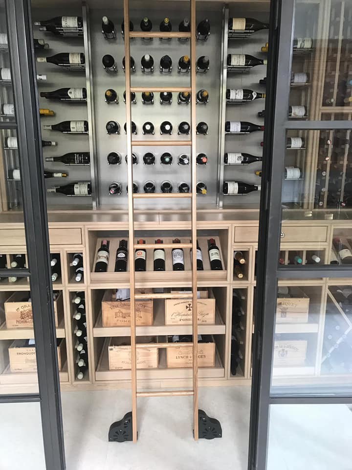 Design ideas for a mid-sized traditional wine cellar in London with storage racks.