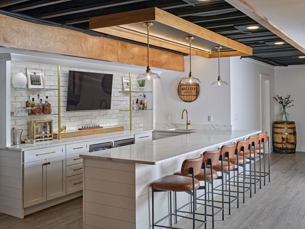 Mid-sized contemporary u-shaped seated home bar in Detroit with a drop-in sink, open cabinets, white cabinets, marble benchtops, white splashback, brick splashback, light hardwood floors, grey floor and white benchtop.