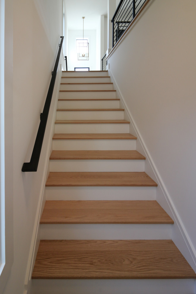 Design ideas for a mid-sized contemporary wood straight staircase in DC Metro with metal railing.
