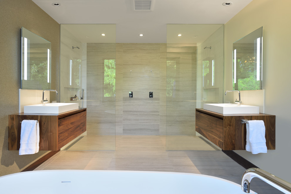 This is an example of a contemporary bathroom in Toronto with a vessel sink, flat-panel cabinets, dark wood cabinets, wood benchtops, a double shower, beige tile and brown benchtops.