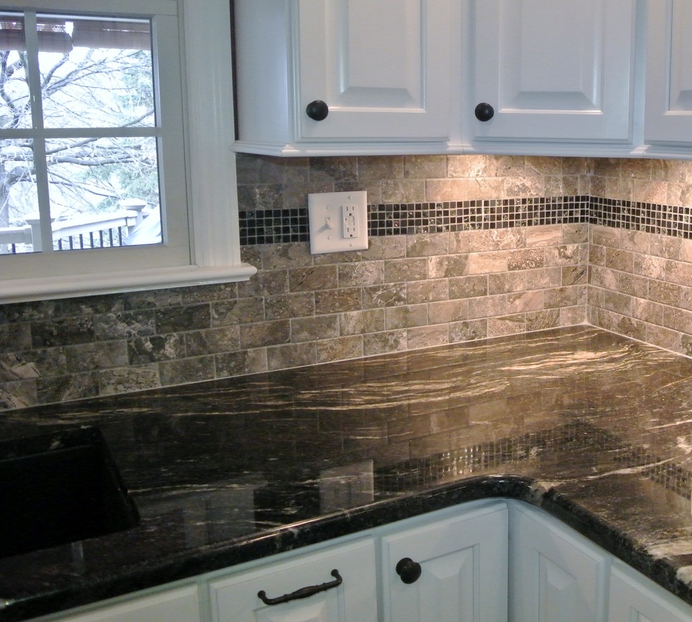 Photo of a transitional kitchen in Other with an undermount sink, white cabinets, granite benchtops, grey splashback, cement tile splashback, porcelain floors and with island.