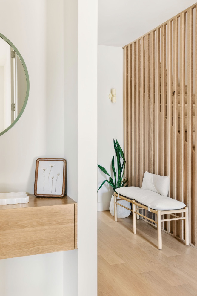 Inspiration for a mid-sized scandinavian light wood floor hallway remodel with white walls
