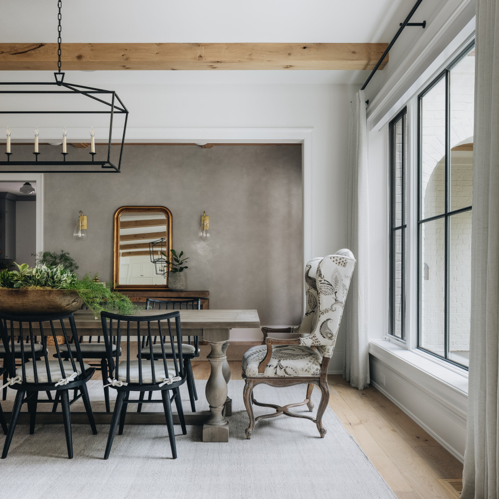 Inspiration for a large transitional open plan dining in Chicago with white walls, light hardwood floors, no fireplace, brown floor and exposed beam.