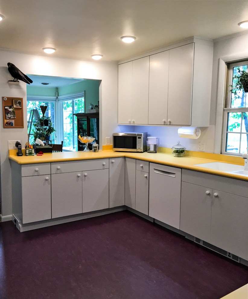 Inspiration for a mid-sized midcentury u-shaped separate kitchen in New York with an undermount sink, flat-panel cabinets, white cabinets, laminate benchtops, white splashback, white appliances, linoleum floors and purple floor.