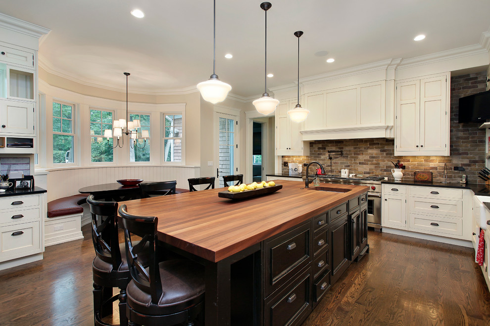 This is an example of a traditional kitchen in Chicago with wood benchtops and brown benchtop.