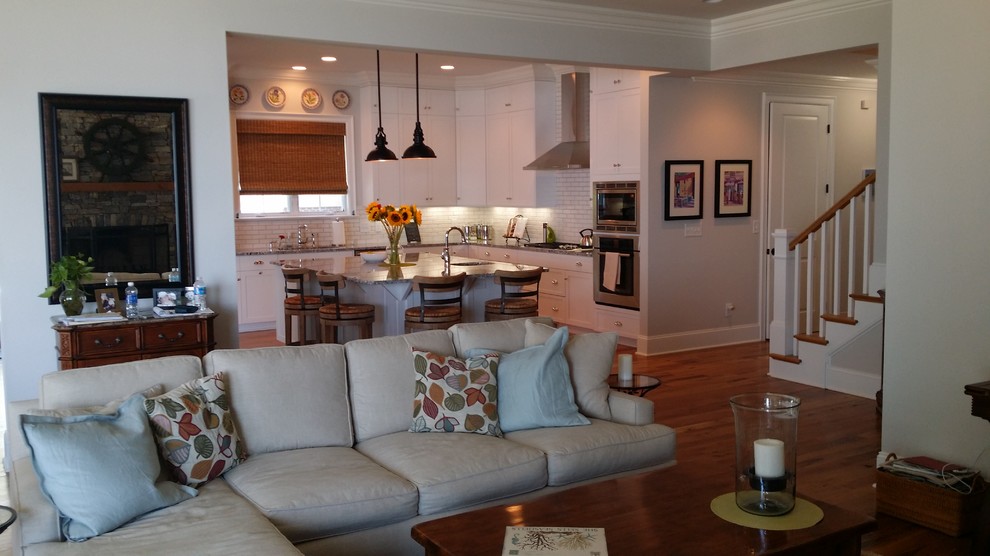Inspiration for a beach style open concept family room in Charlotte with light hardwood floors.
