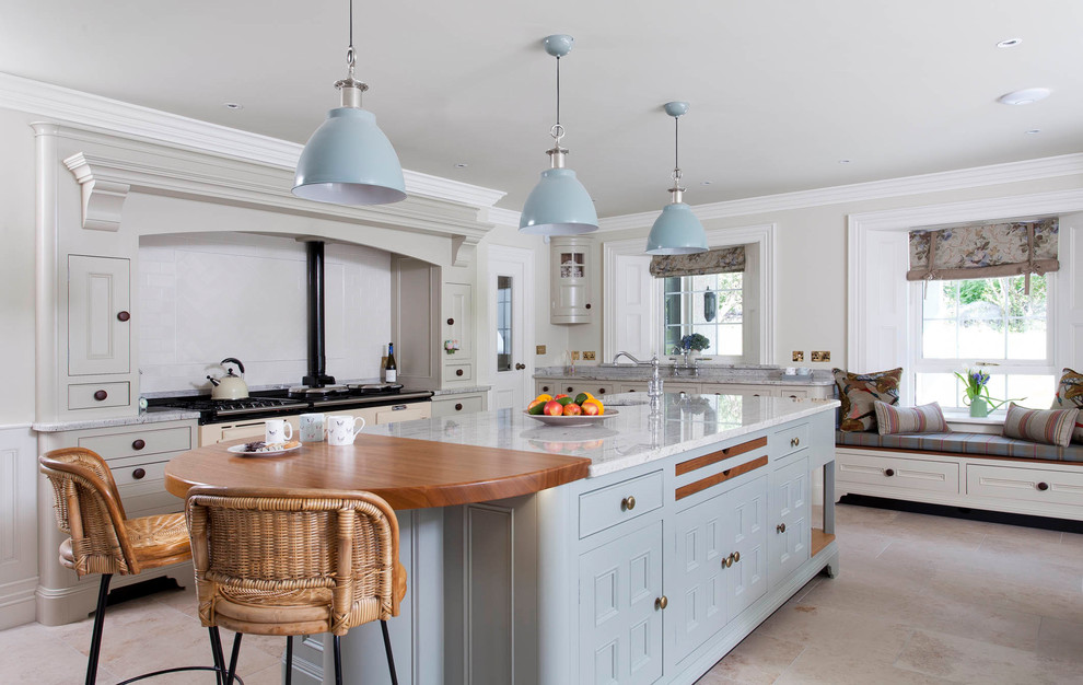 Inspiration for a large country l-shaped open plan kitchen in Belfast with an undermount sink, beaded inset cabinets, blue cabinets, quartzite benchtops, white splashback, ceramic splashback, panelled appliances, ceramic floors, with island and grey floor.