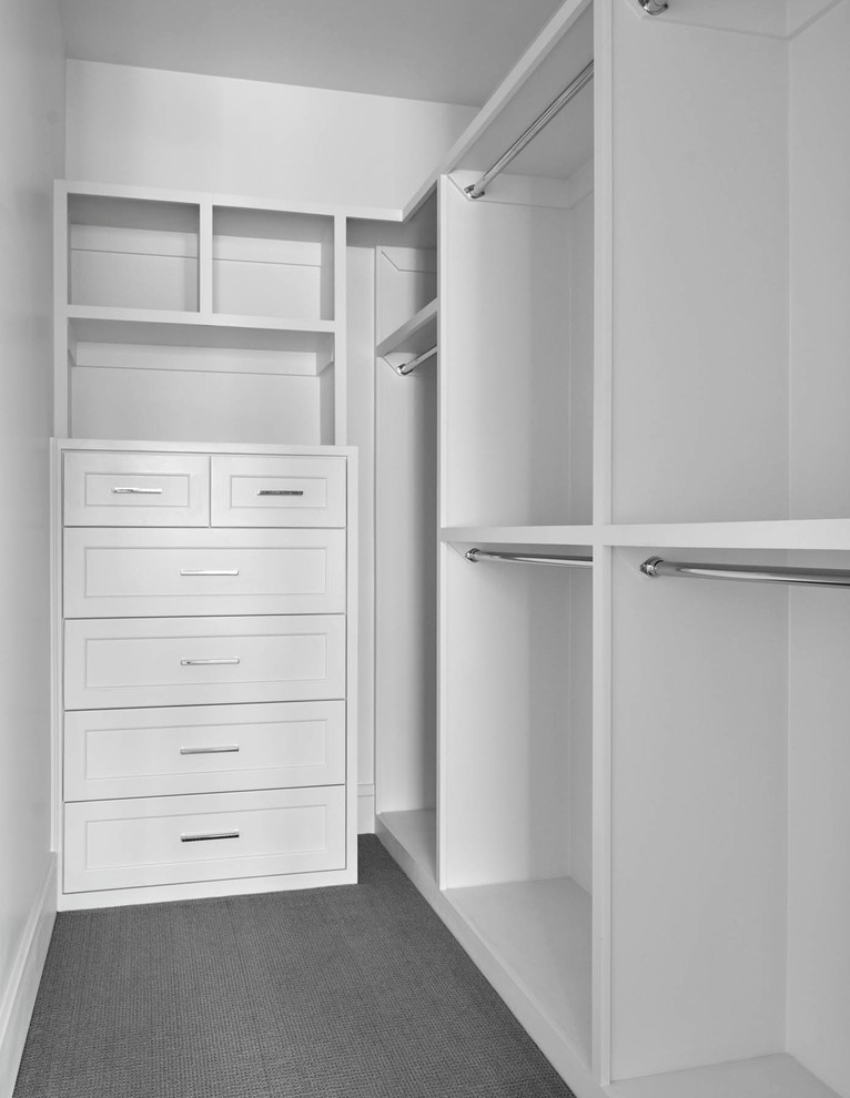 Photo of a large transitional gender-neutral walk-in wardrobe in Dallas with recessed-panel cabinets, white cabinets and carpet.
