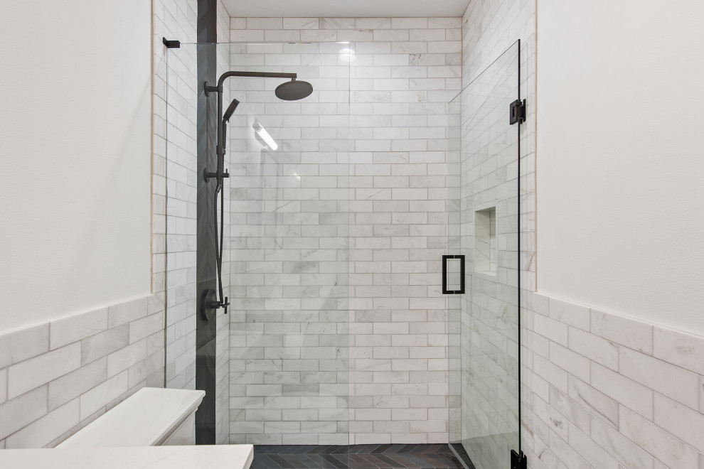 Photo of a mid-sized transitional 3/4 bathroom in Dallas with recessed-panel cabinets, dark wood cabinets, an open shower, gray tile, marble, white walls, porcelain floors, an undermount sink, engineered quartz benchtops, black floor, a hinged shower door, white benchtops and a built-in vanity.