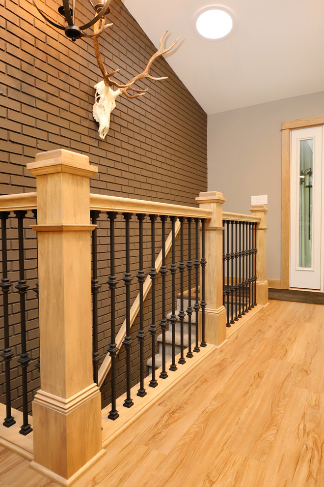 Inspiration for a mid-sized transitional light wood floor and brown floor front door remodel in Grand Rapids with gray walls and a white front door