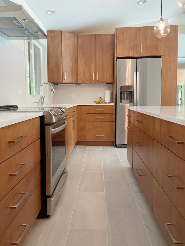 Inspiration for a mid-sized midcentury u-shaped kitchen in St Louis with an undermount sink, flat-panel cabinets, medium wood cabinets, quartzite benchtops, white splashback, porcelain splashback, stainless steel appliances, porcelain floors, with island, grey floor, white benchtop and vaulted.